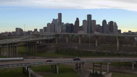 Ascending-drone-shot-that-reveals-downtown-Houston,-Texas-and-surrounding-landscape