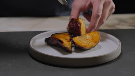 Slow-motion-shot-of-a-chef-plating-a-gourmet-sweet-potato-dish-in-a-restaurant