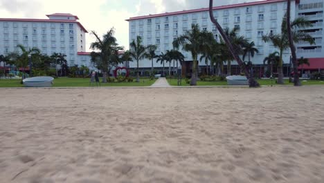 Low-angle-pull-away-drone-shot-of-beachfront-of-Crown-Plaza-Resort