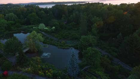 Tracking-shot-of-a-beautiful-pond-surrounded-by-trees-next-to-the-ocean-with-morning-sunrise-beaming-in