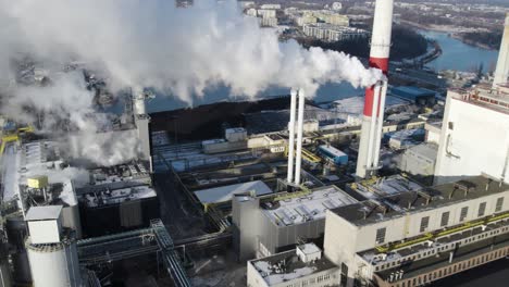 Aerial-shot-of-curling-steam-from-a-chimney-of-a-thermal-power-plant-in-Poland