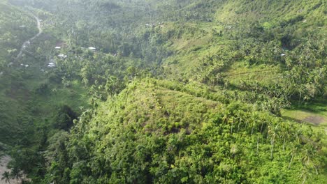 A-flight-over-a-little-village,-in-the-mountains-of-the-Philippines