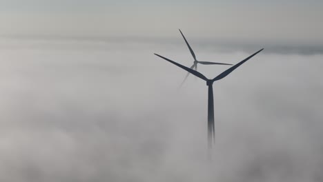 Misty-ground-fog-surround-windmills-during-the-early-morning-day-break