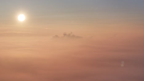 Golden-sunrise-drone-view-hovering-over-top-of-morning-fog