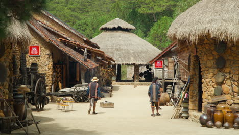 Vietnamese-People-In-Traditional-Clothes-Walking-Along-Old-Ethnic-Cu-Lan-Village-in-Da-Lat-City,-Vietnam---slow-motion