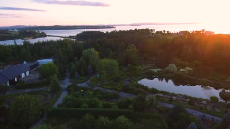 Luftaufnahme-Atemberaubender-Gärten-Mit-Blick-Auf-Einen-Wunderschönen-Sonnenaufgang-über-Dem-Meer