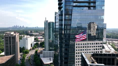 Cinematic-drone-shot-of-the-American-flag-waving-at-building-top,-Atlanta,-Georgia,-USA