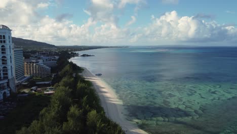 Drone-shot-of-coastline-of-Saipan,-Northern-Mariana-Islands-during-a-calm-morning