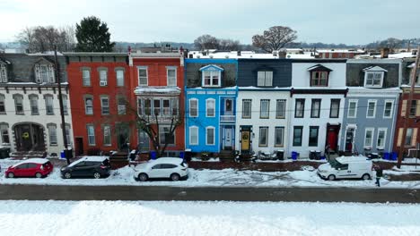 Snow-covered-colorful-row-houses-and-parked-cars-on-a-clear-winter-day