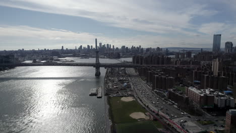 Aerial-View-Of-East-River-With-Williamsburg-Bridge-And-Traffic-Along-FDR-Drive
