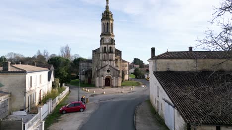 Notre-Dame-church-in-Bayon-sur-Gironde,-France---aerial-flyover