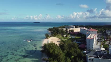 Drone-shot-of-a-hotel-along-coastline-of-a-tropical-island