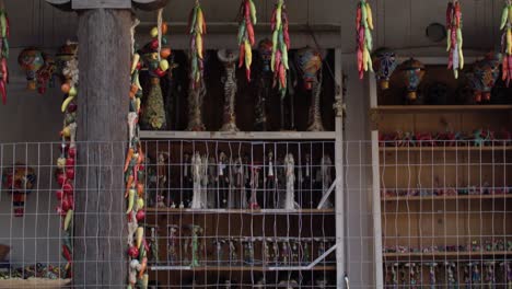 Chili-peppers-hanging-to-dry-in-downtown-Santa-Fe,-New-Mexico-with-video-tilting-up