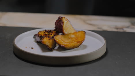 Slow-motion-shot-of-a-chef-plating-a-gourmet-sweet-potato-dish-in-a-restaurant