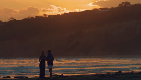 Young-Lovers-Sharing-A-Glass-Of-Wine-At-The-Beach-During-Sunset