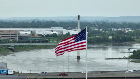 American-flag-waving-above-Missouri-River-at-Omaha,-Nebraska-waterfront