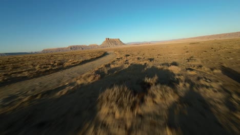 Fast-drone-flight-around-4wd-sport-utility-vehicle-and-down-scenic-Utah-desert-road