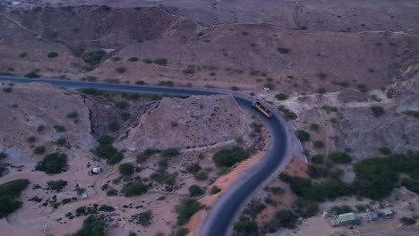 Aerial-view-of-Mukran-National-Highway-as-a-loaded-truck-is-going-down-the-road,-Balochistan,-Pakistan