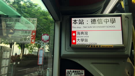 Monitor-screen-showing-stop-destinations-on-the-bus,-Victoria,-Hong-Kong,-China
