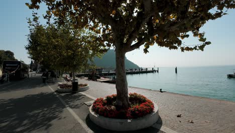POV-Walking-Along-Lake-Garda-Promenade-Towards-On-Sunny-Day