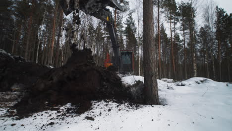 large-excavator-digging-and-dropping-dirt-pile-in-forest