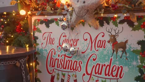 Close-up-establisher-entrance-sign-of-The-Ginger-Man-Christmas-Garden,-night
