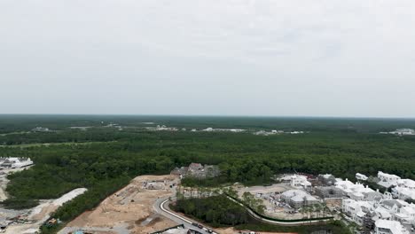 closing-up-motion-View-of-green-woods-and-land-avaible-for-development-with-some-buildings-and-part-of-the-town-at-Arys-beach-FL