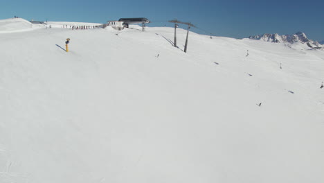 Verschneite-Piste-Mit-Skilift-Und-Skifahrern-In-Saalbach-Hinterglemm,-Österreich---Drohnenaufnahme