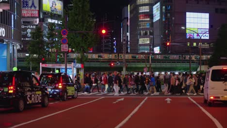 Slow-motion-Pan-shot-of-Crossing-in-Shijuku-to-Kabukicho-at-night-in-mega-city