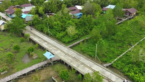 Flying-drones-show-people-riding-motorbikes-on-the-boards-of-the-Agats-Asmat-city-of-Papua