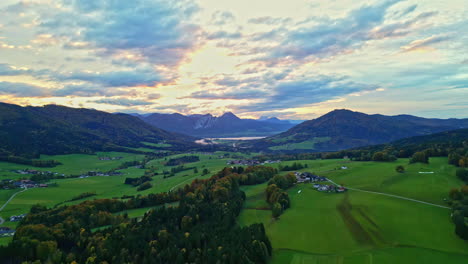 lush-valley-with-mountains-during-sunset,-serene-and-majestic-landscape-aerial-view
