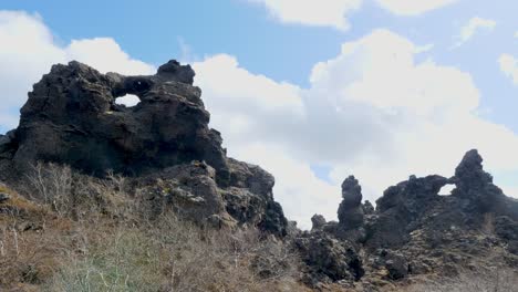 Timelapse-of-rugged-lava-formations-at-Dimmuborgir-in-Iceland,-showcasing-nature's-artistry-under-a-cloudy-sky