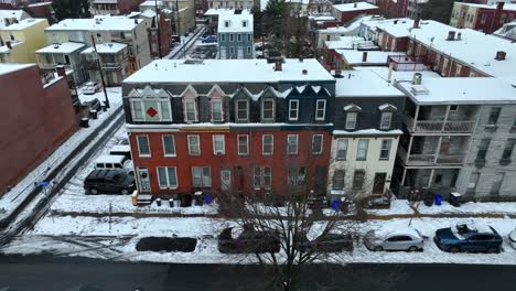 Snow-dusted-rooftops-of-colorful-townhouses-on-an-urban-street