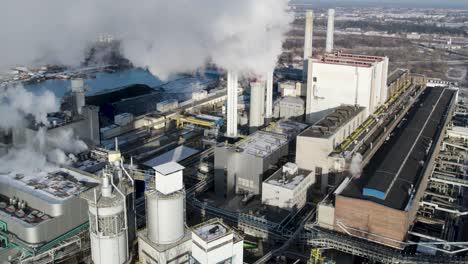 Steam-rising-from-heat-energy-power-plant-during-winter-aerial