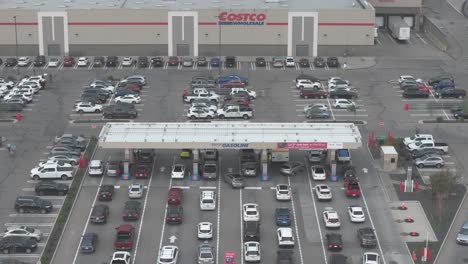A-line-up-of-vehicles-waiting-to-fill-up-with-gas-at-the-Heritage-Meadows-Costco-in-Calgary-Alberta-as-seen-from-an-overhead-aerial-drone