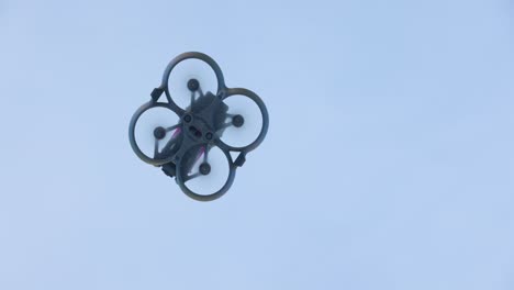 Low-angle-view-of-quadcopter-drone-flying-above