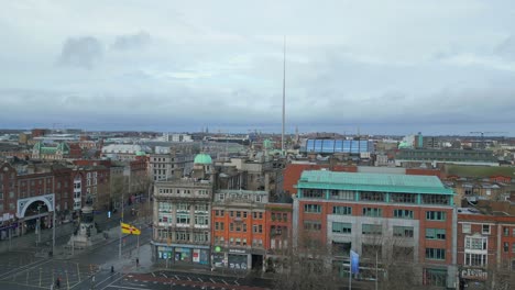 Aerial-pan-shot-in-Dublin-City-showcasing-the-Spire-and-O'Connell's-Monument