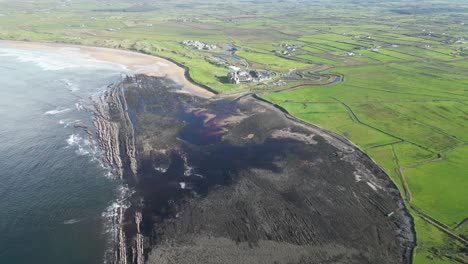 High-aerial-dolly-shot-overhead-Doughmore-Bay-with-Trump-Doonbeg