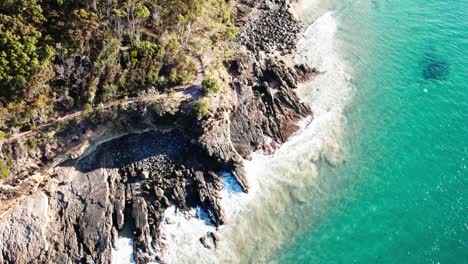 Rocky-Cliffs-And-Ocean-In-Noosa-Shire,-Queensland,-Australia---Drone-Shot