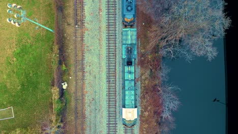 Freight-Train-Rolling-Through-A-Landscape,-Aerial-Panorama