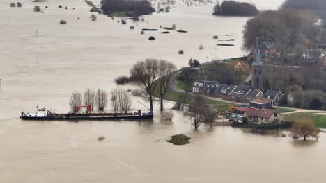 Aerial-orbiting-view-of-a-shipped-beached-along-the-Waal-River-next-to-the-town-of-Gorinchem-after-the-flood-waters-have-inundated-much-of-the-surrounding-countryside