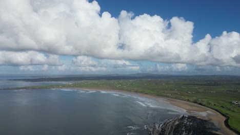 Aerial-establishing-shot-of-Doughmore-Bay-on-a-cloudy-summers-day
