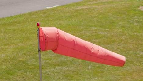 High-angle-view-of-an-airport-windsock-blowing-in-strong-wind
