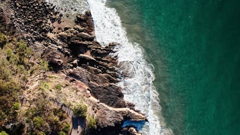 Top-Down-View-Of-Cliffs-And-Ocean-In-Noosa,-Queensland,-Australia---Drone-Shot
