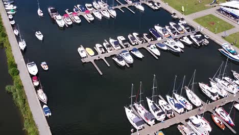 Docked-yachts-and-sailboats-in-local-pier,-aerial-drone-view