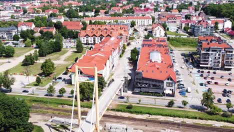 Red-rooftops-and-bridge-of-Gizycko-in-Poland,-aerial-view