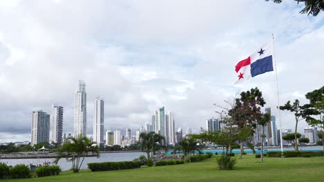 The-national-flag-of-Panama-gently-waving-the-wind-against-a-backdrop-of-modern-tall-buildings-and-skyscrapers-near-the-coastline