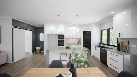 modern-black-and-white-open-planned-kitchen-with-stone-bench-tops-and-elegant-pendant-lights