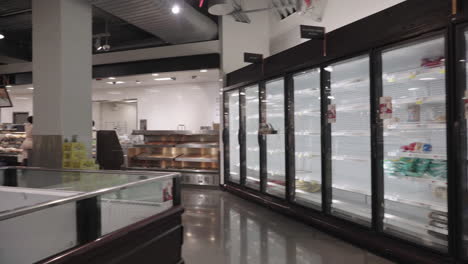 Pan-on-empty-fridges-rotisserie-and-open-fridge-at-supermarket