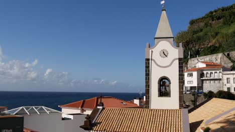 Uhrturm-An-Der-Küste-Mit-Bergen-Rundherum-Auf-Der-Insel-Madeira,-Portugal